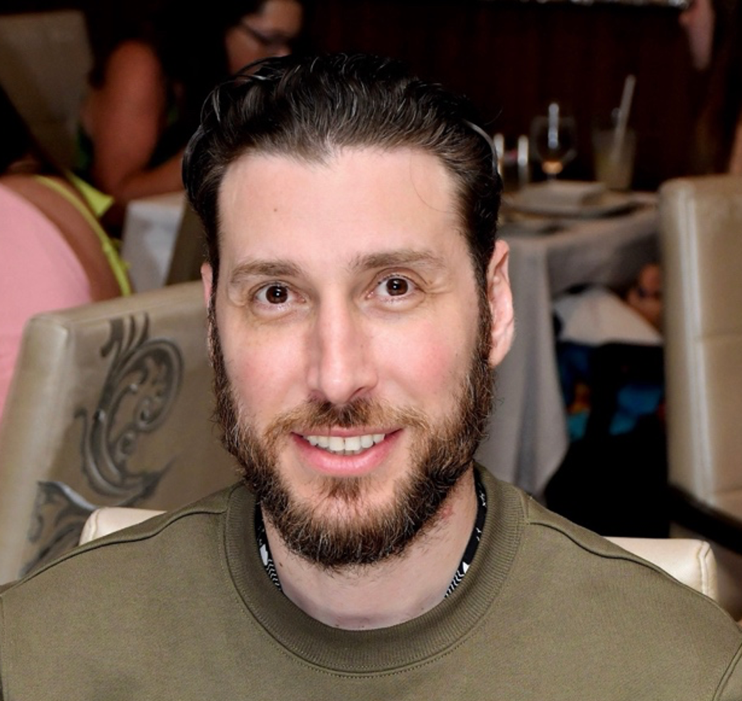 A person with a beard AI-generated content may be incorrect.