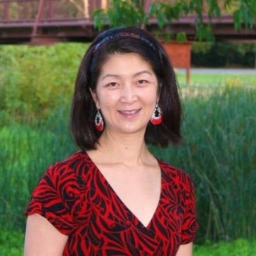 A person in a red dress AI-generated content may be incorrect.