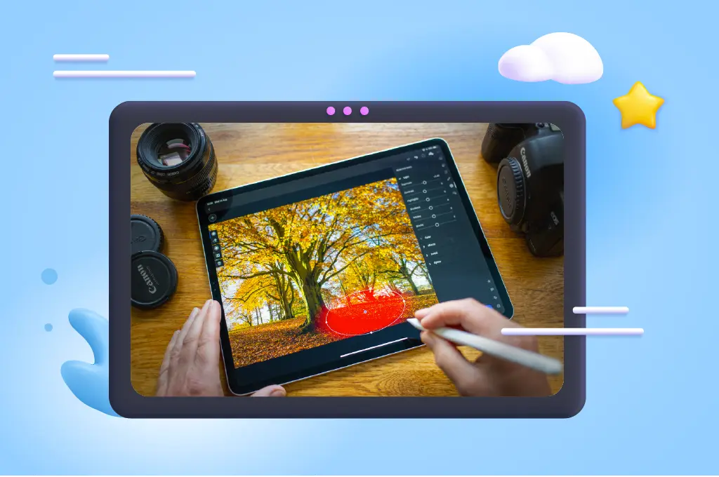 Fotografia de uma mesa com um tablet que tem o lightroom aberto com uma foto de uma árvore e uma mão com caneta digital selecionando uma parte da foto