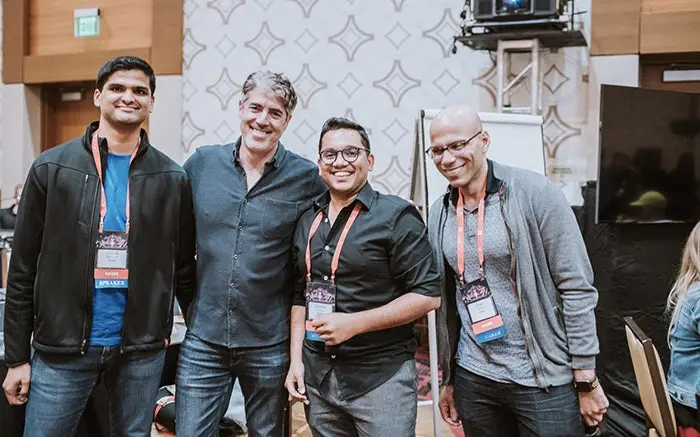 Four members of the Adobe XD team pose for the camera at the UX Summit in 2018.
