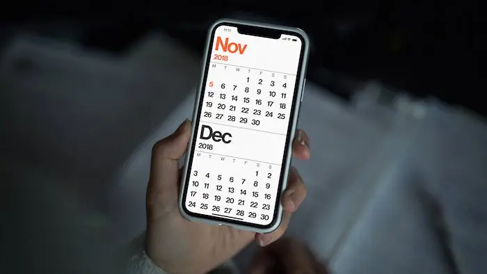 A photograph of the minimal calendar default view presented on an iPhone X.
