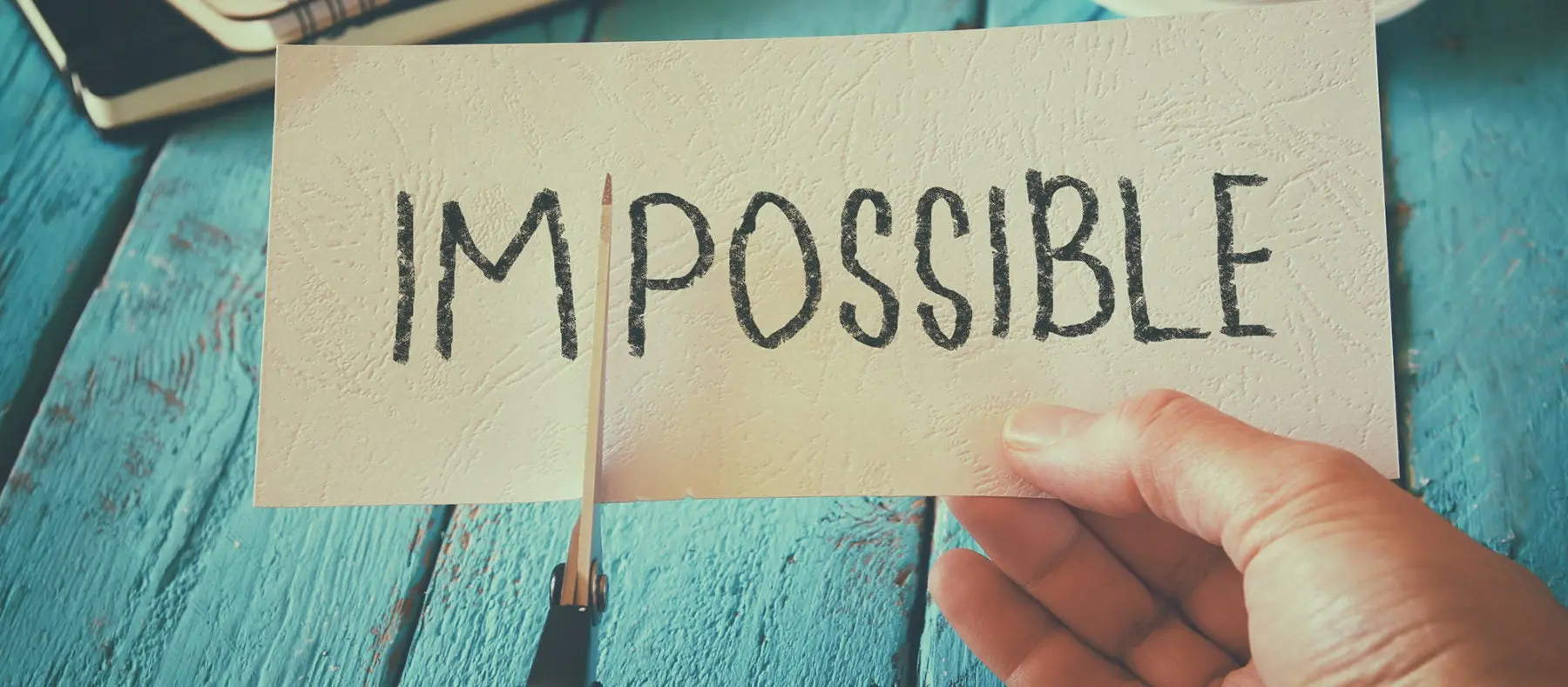 The word Impossible being cut into I'm Possible.