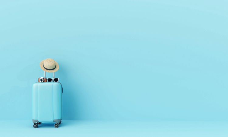 Blue suitcase against blue background