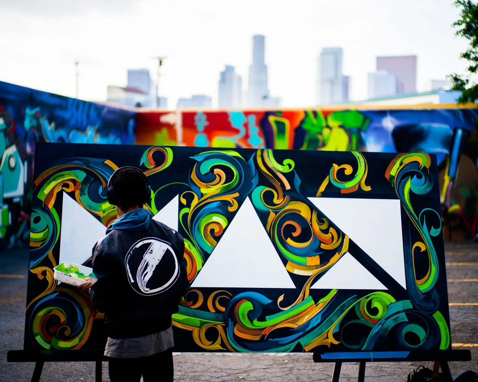 A man paints on a canvas.