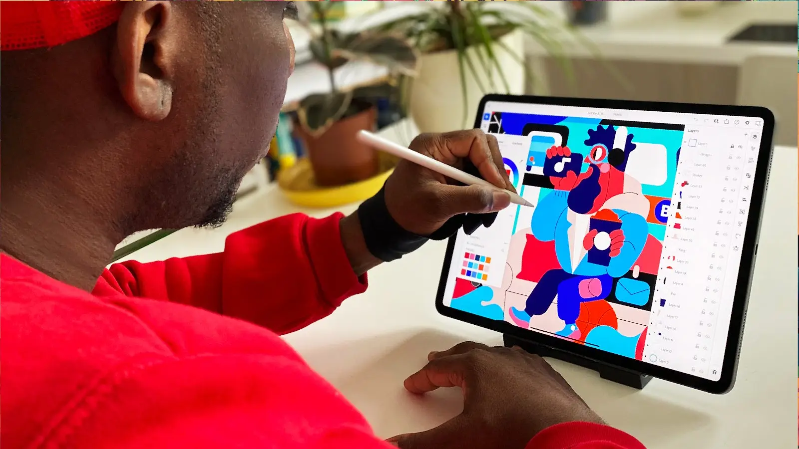 A man is shown drawing a vector illustration on Illustrator on the iPad.