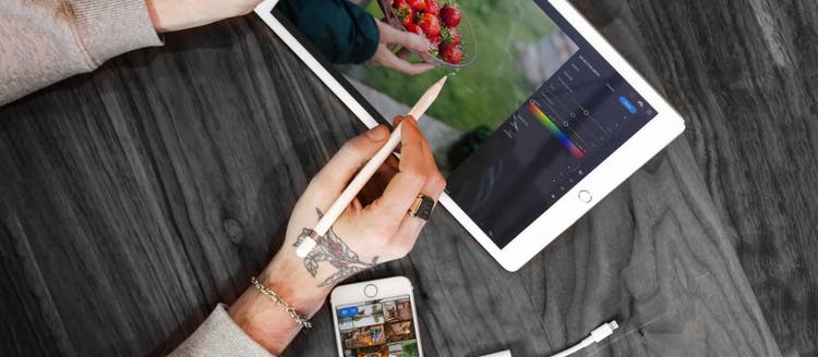 Person putting pencil to tablet.