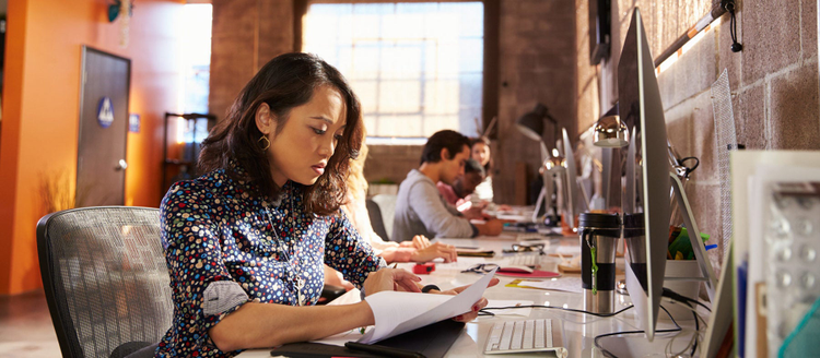 A woman works at her desk.