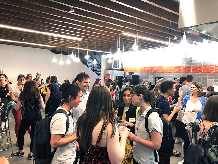 Attendees at the Ladies that UX Boston Chapter network in the cafeteria.