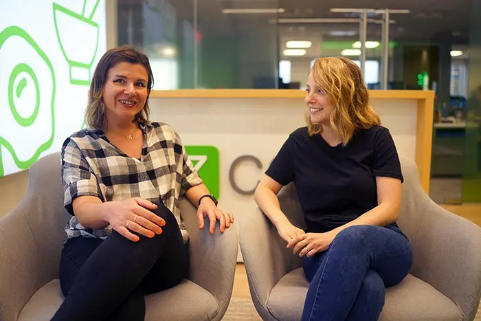 Lara Cavezza and Olga V. Perfilieva sit together at the EzCater offices.