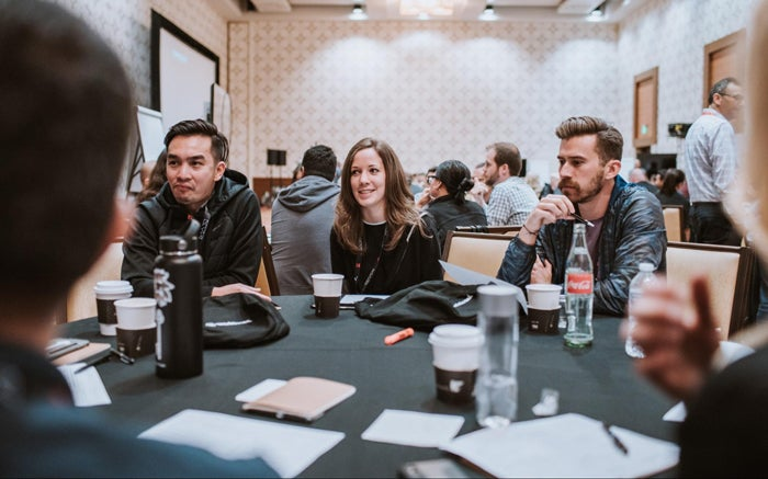 Cody Brown (right) and fellow designers collaborate at Adobe MAX's UX Leaders Summit.