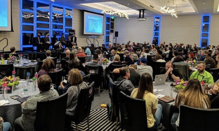 Wide angle view of the MAX 2018 Educator Day audience and discussion panelists.