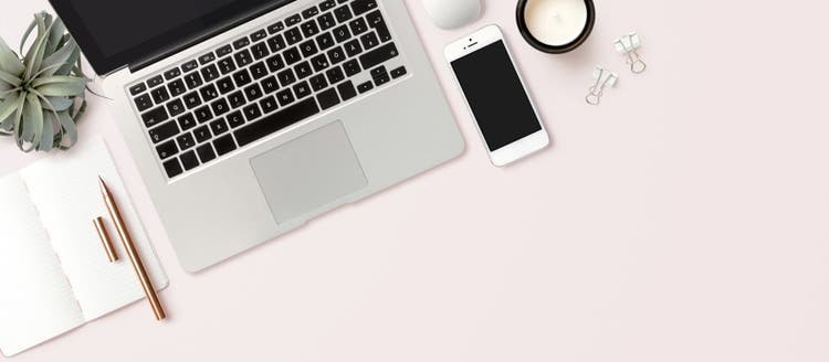 Laptop and phone on desk.
