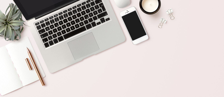 Laptop and phone on desk.