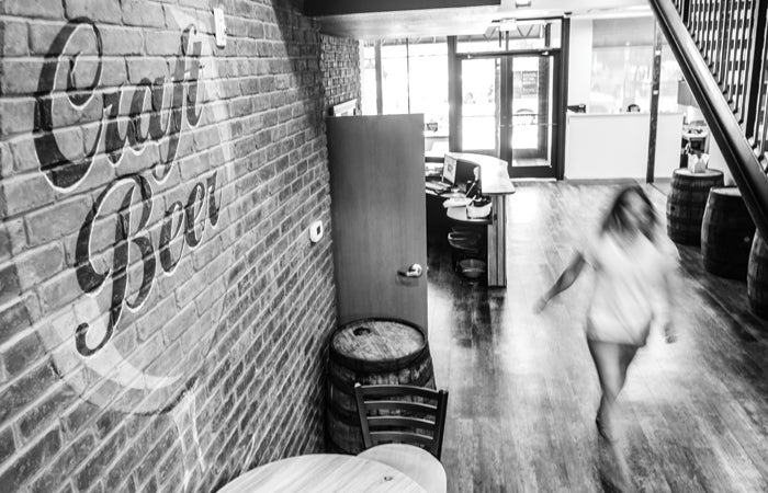 A staff member walks by a craft beer logo at the Brewers Association headquarters.