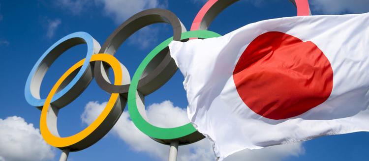 Olympic rings. Japanese flag flies nearby.