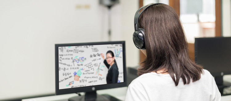 Asian woman student video conference e-learning with teacher on computer in IT room at university.