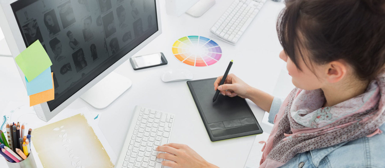 Artist drawing something on graphic tablet at office