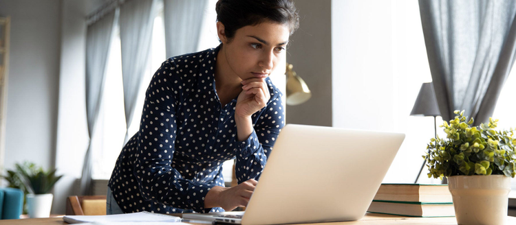 Young Indian woman working on computer.