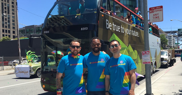 Damon posing with his colleagues at a Pride Parade.