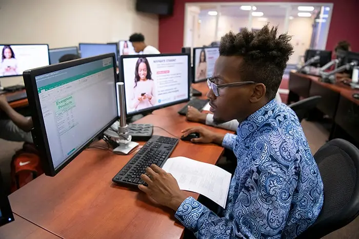 A student studies a computer screen.