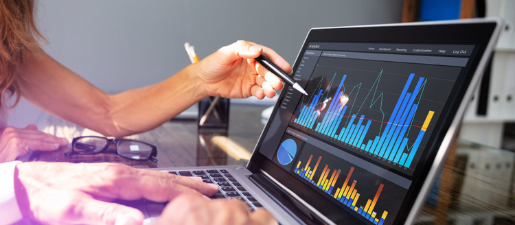 Close-Up Of Office Workers Analyzing Graph On Laptop