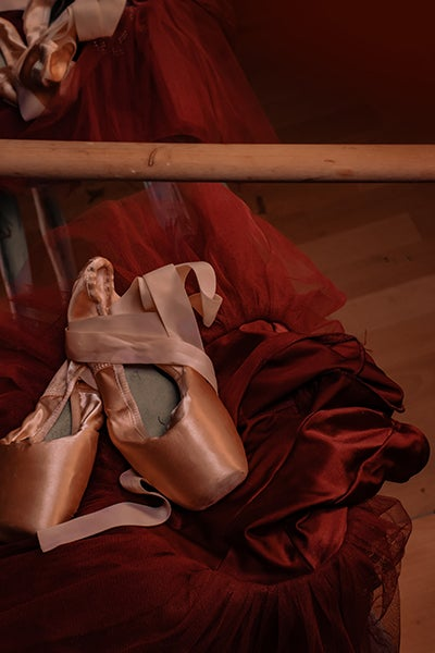 Ballet slippers on a red chair