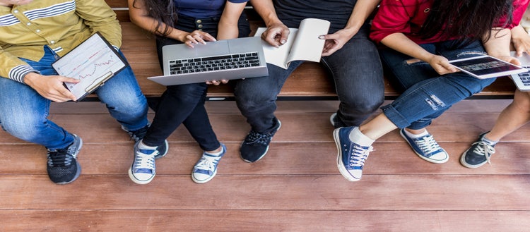 Group of students on electronic devices.