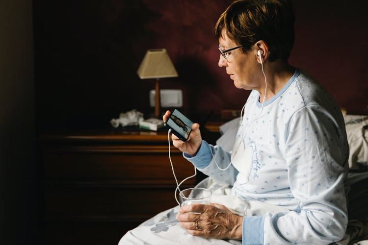 Woman watching video on smartphone.