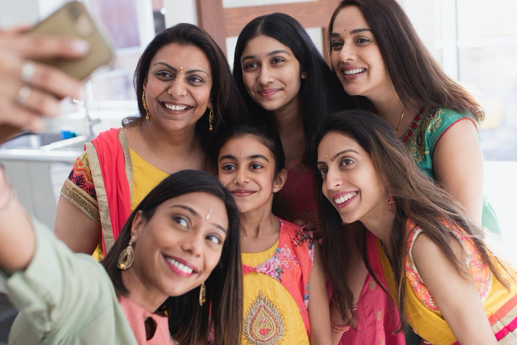 Group of women taking a group selfie.