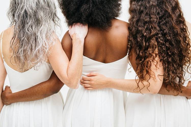 3 women in white dresses.