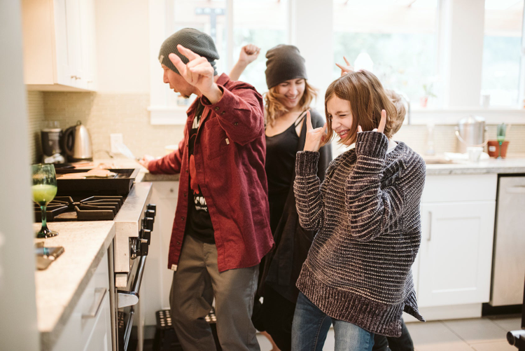 Young people in kitchen danciing