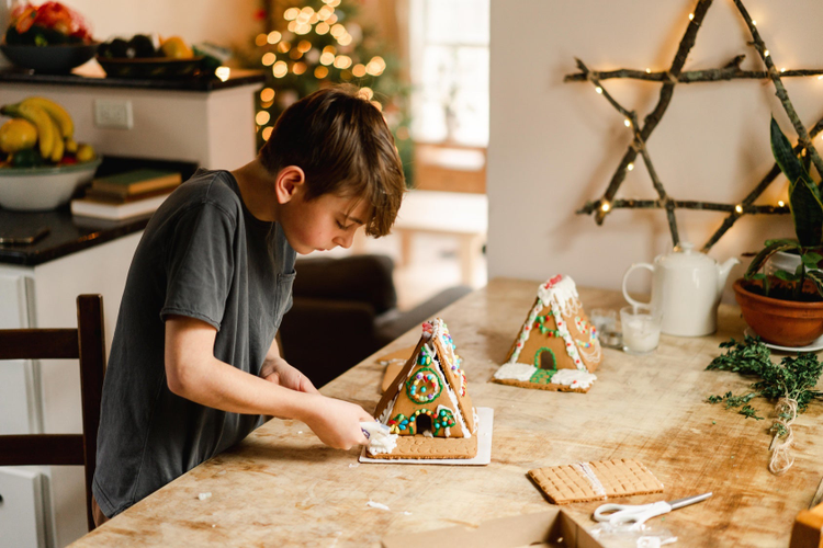 Boy working on Gingerbread house