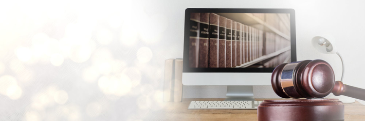 Image of a computer, books and a gavel