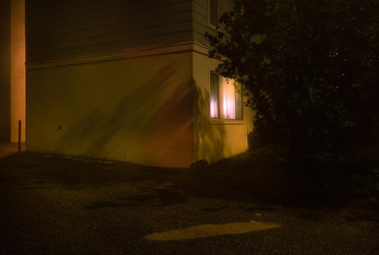 View of corner house at night.