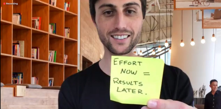 Man holding sticky note. Effort now=results later.