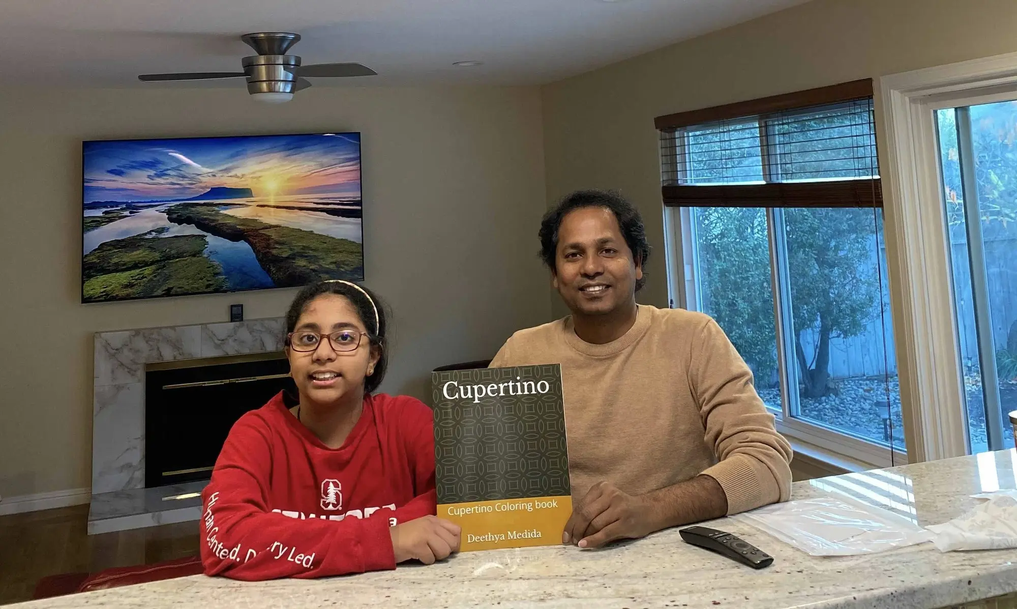 Nag Medida and his daughter with the book they created together. 