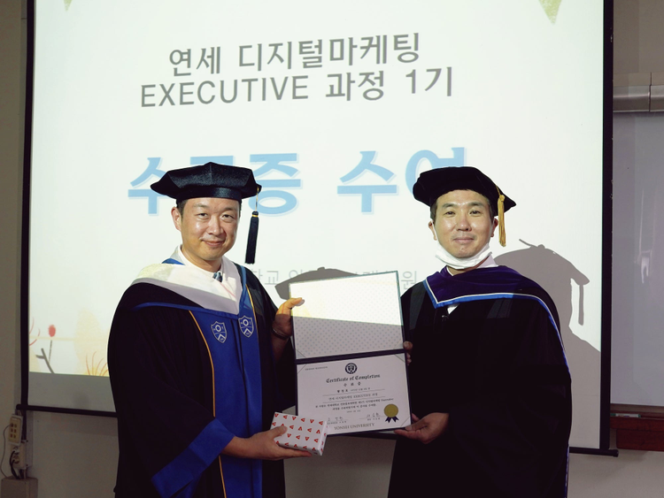 Dennis Hwang (left) at graduation day with the Dean of the Graduate School of Journalism & Mass Communication at YONSEI University, Seoul, South Korea. 