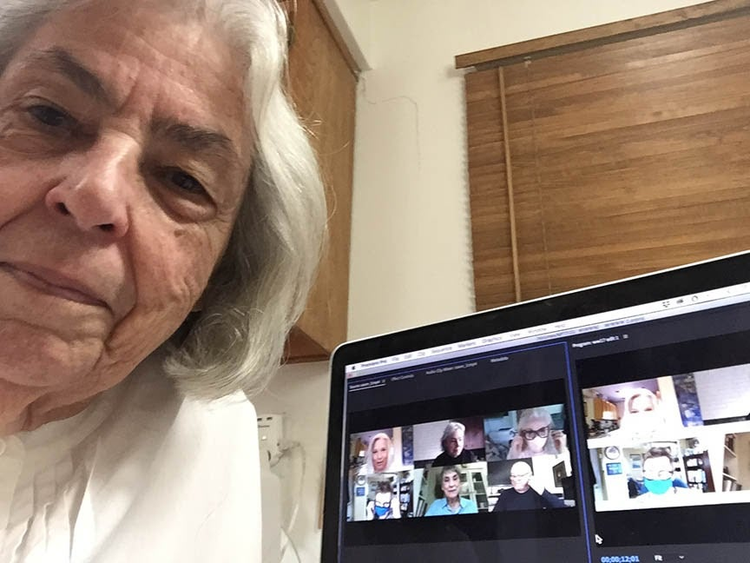 Senior woman in front of computer screen of a zoom call. 