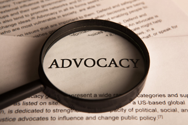 Picture of magnifying glass on word Advocacy