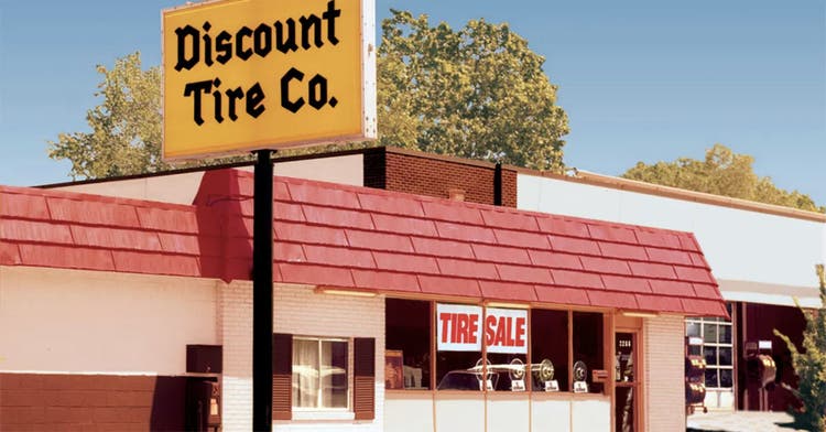 A photograph of the early days of a storefront of Discount Tire Co.
