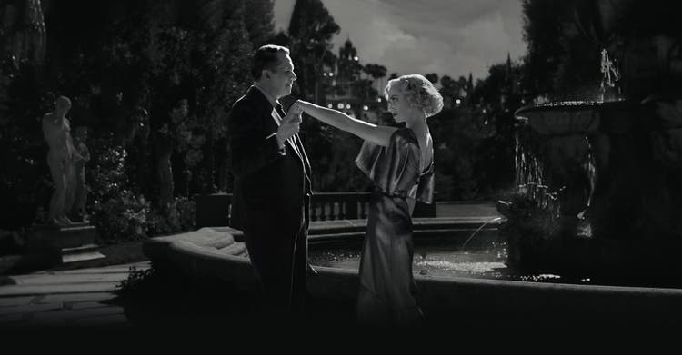 Black and white photo showing a man and woman dancing.