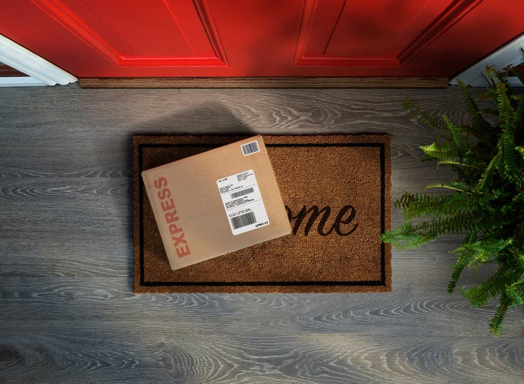 Express box on a doormat in front of a door.