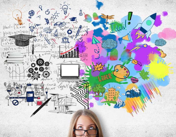 Girl wearing glasses looking up at a space full of colorful and black and white ideas. 