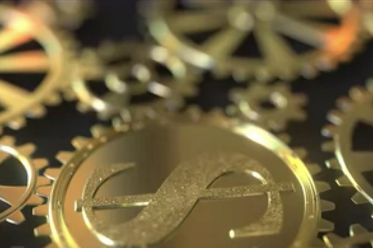 Photo of gold gear with money symbol on it. 
