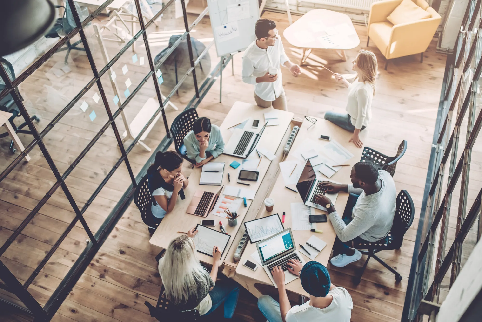 Team working around a desk in a well-lit office