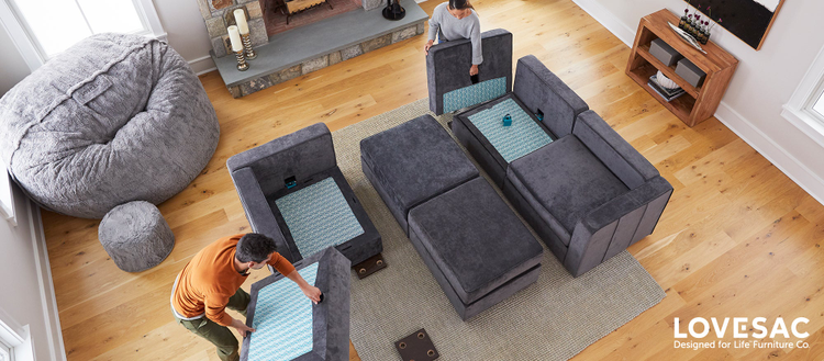 Arial view of a family room with people setting up a LoveSac Sactioinal. 