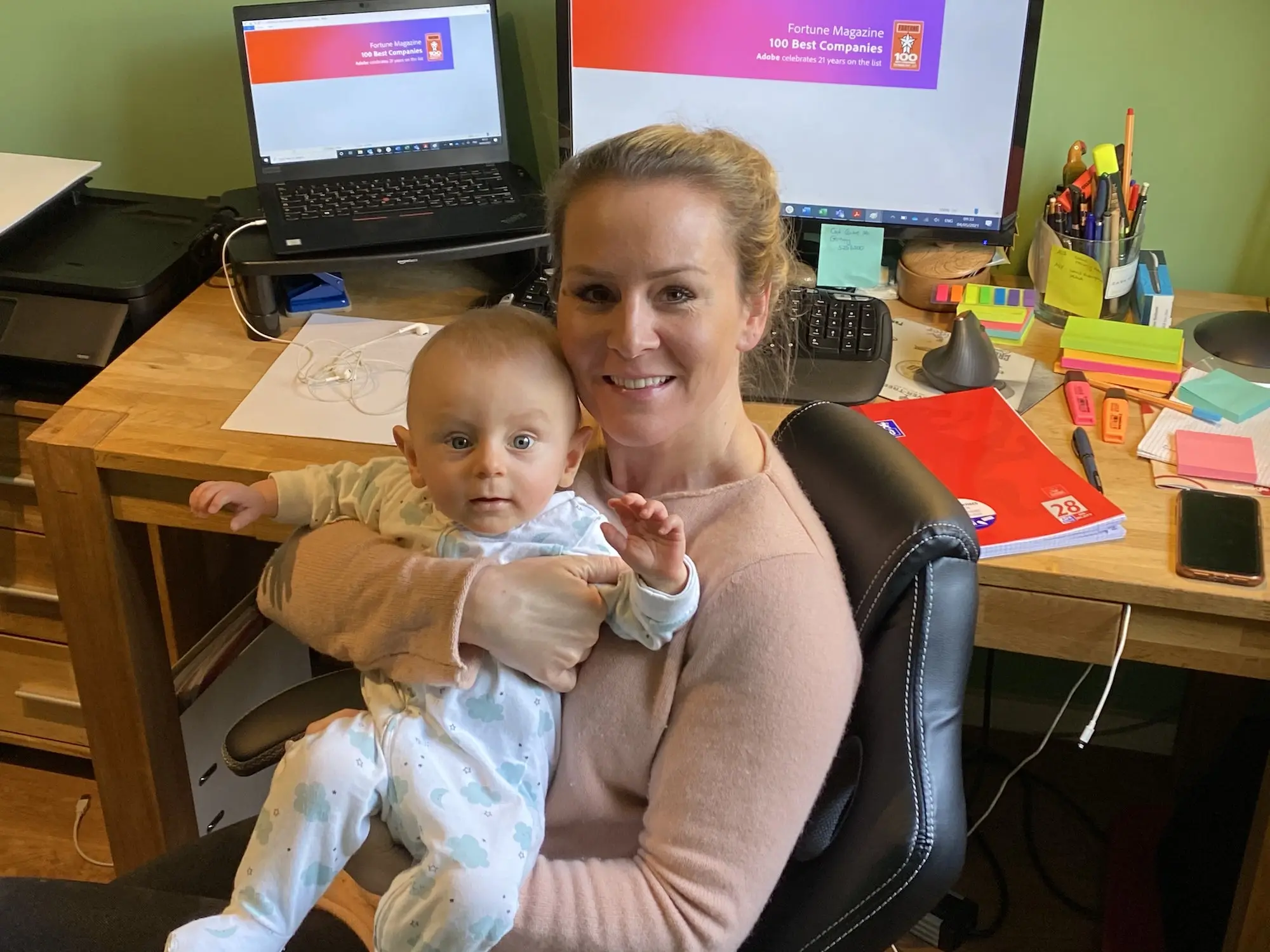 An Adobe mom working from home with her baby.