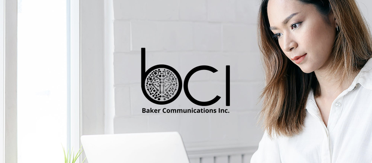 Woman looking at computer screen with Baker Communications Inc. text. 