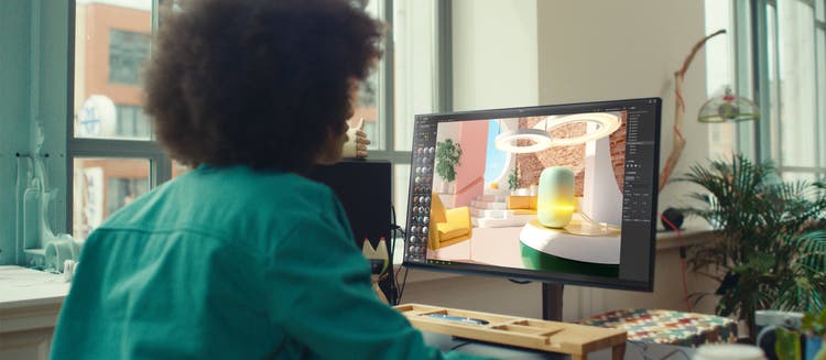 Woman using Adobe Substance 3D on a computer screen.