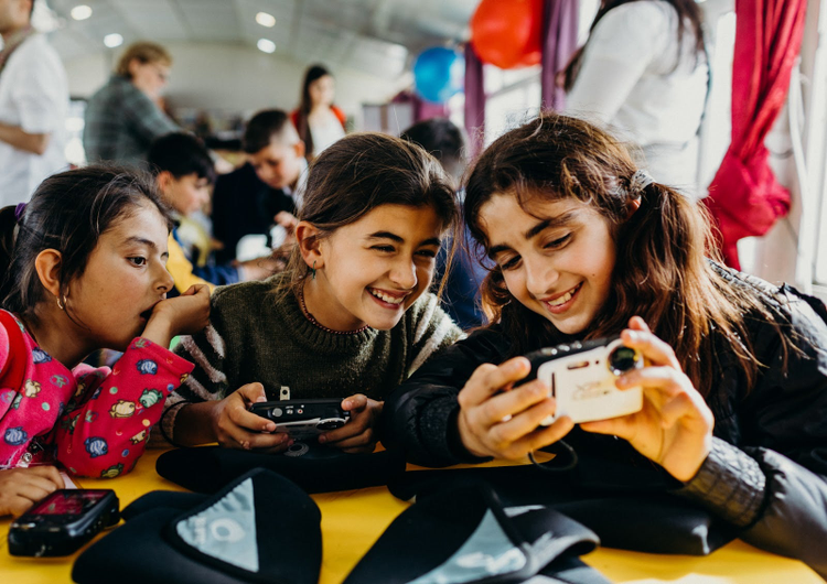 Three girls looking at a camera. 